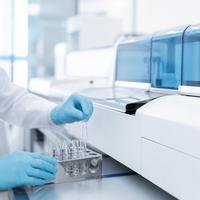A sample being placed into an analyser in a clinical laboratory